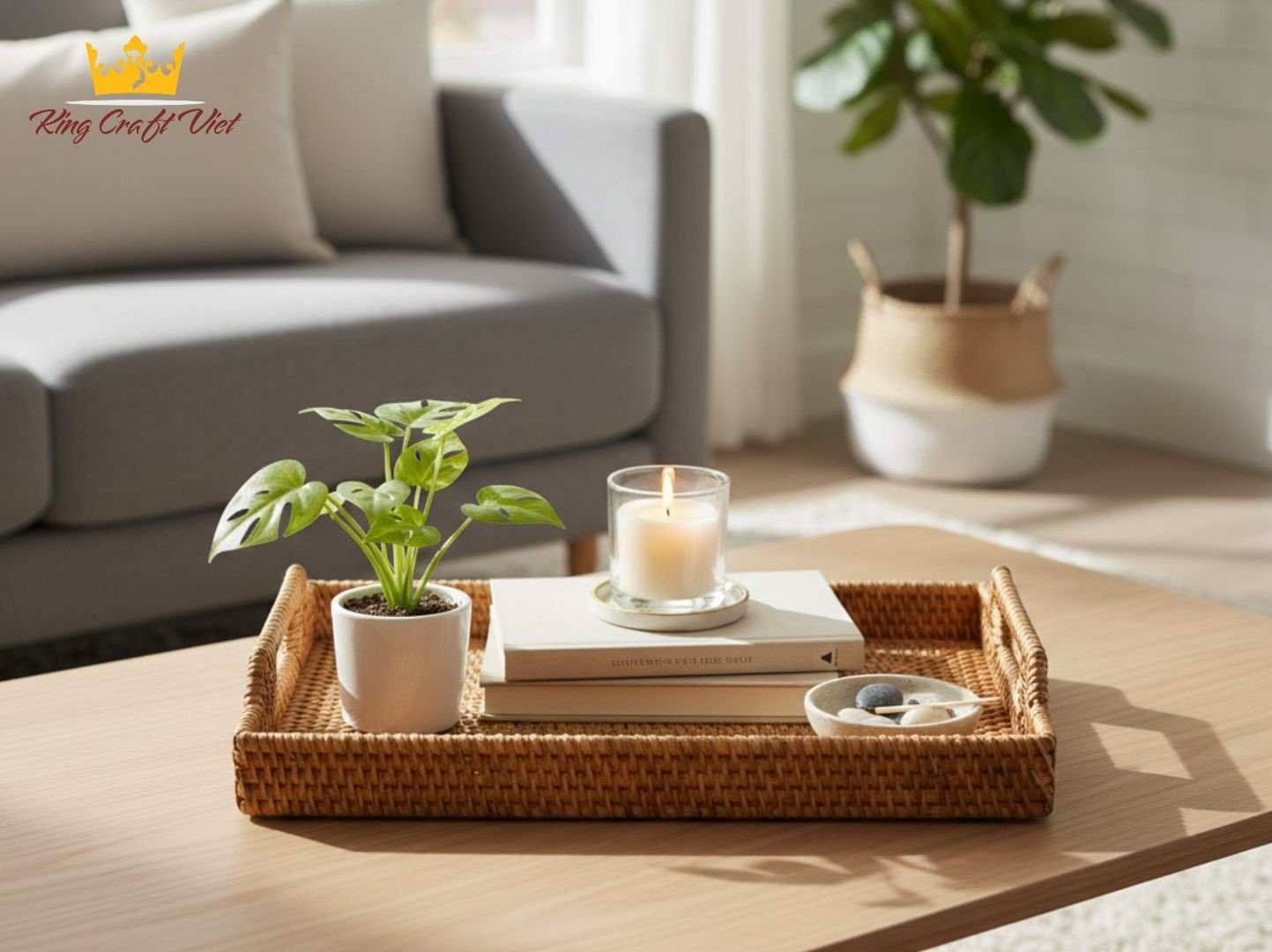Handwoven rattan tray styled with candles and books on a coffee table
