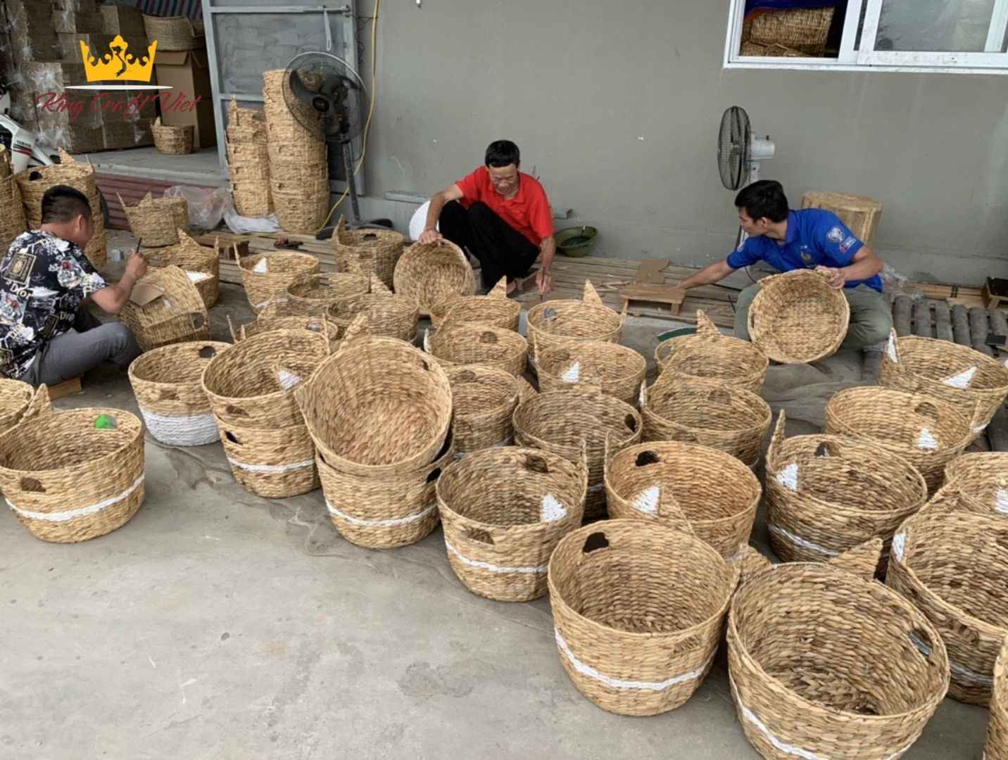 Vietnamese artisans weaving and finishing water hyacinth baskets